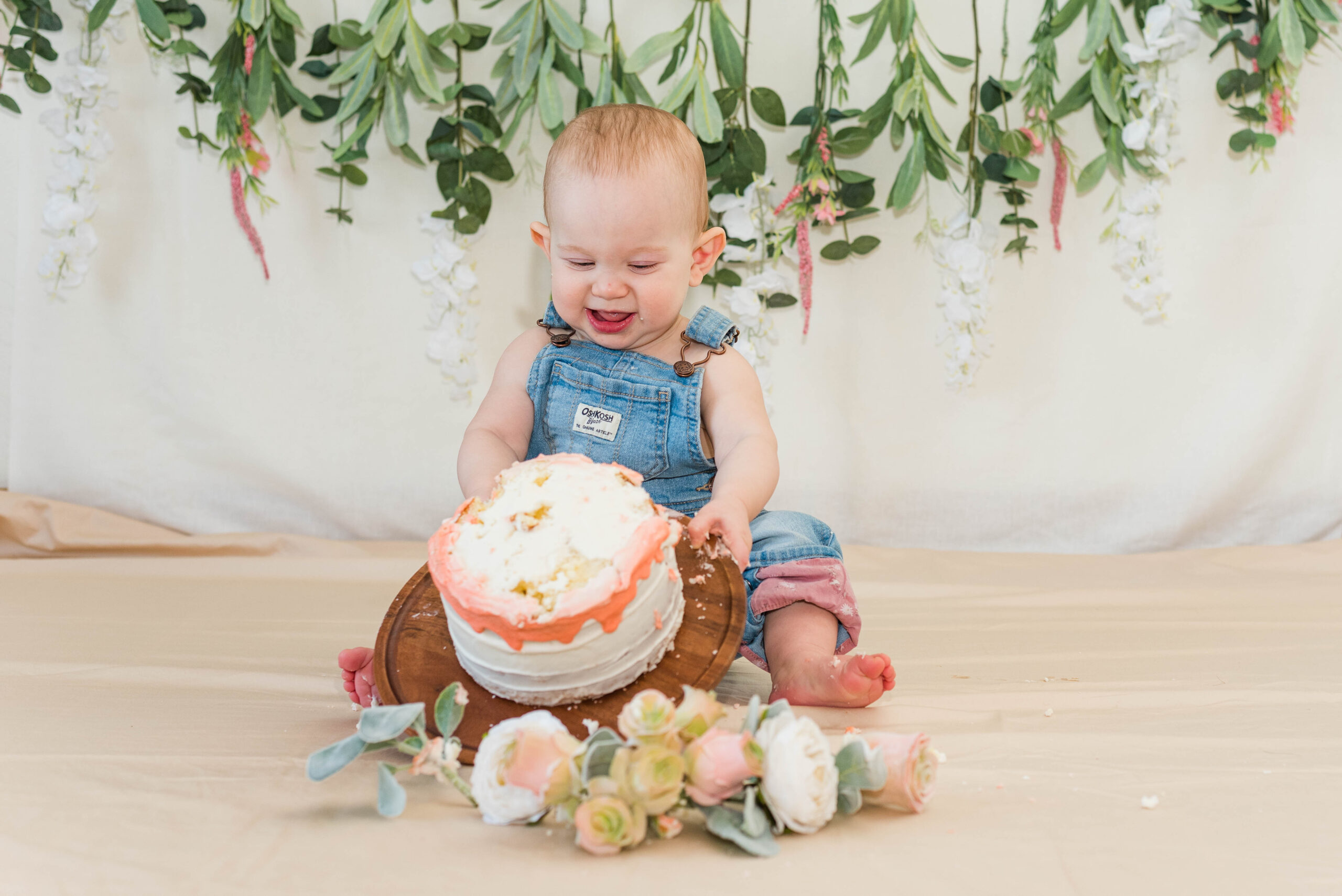 Cake Smash Session of little one tipping over their cake.