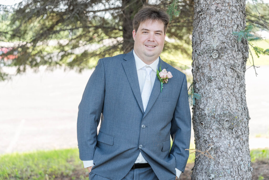 Groom portrait standing outside before his wedding at Cormorant Lutheran Church in Cormorant, MN 