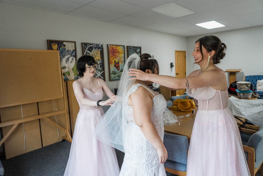 Bride and bridesmaids getting ready before her wedding at Cormorant Lutheran Church in Cormorant MN. 