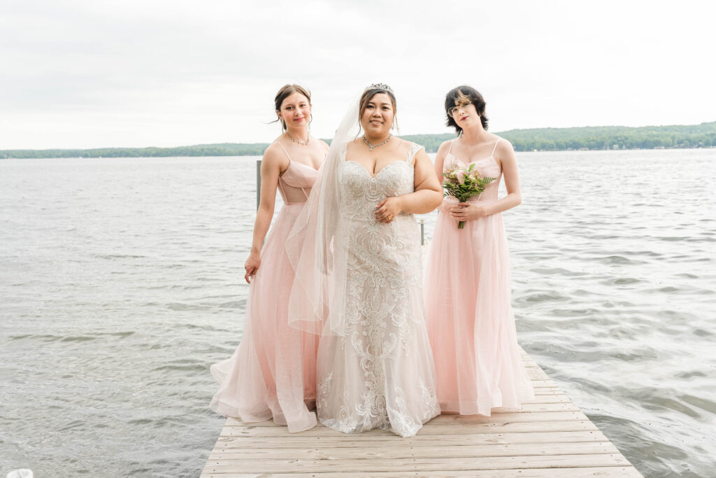 Bride and bridesmaids standing on a dock at Fair Hills Resort in Detroit Lakes, MN 