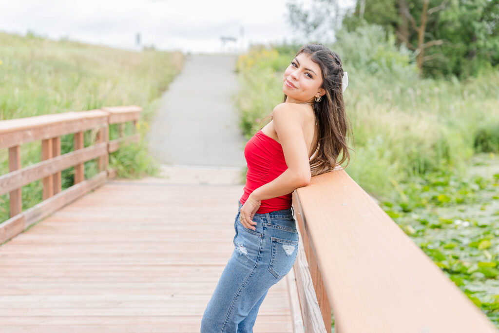 Senior Session in Vergas, MN. Girl wearing Red Top, jeans and black heels 