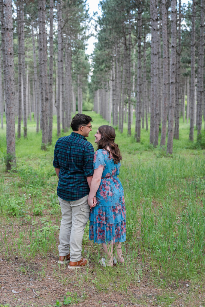 Two people standing in a park with tall trees at Montissippi Regional Park, Monticello, Minnesota 